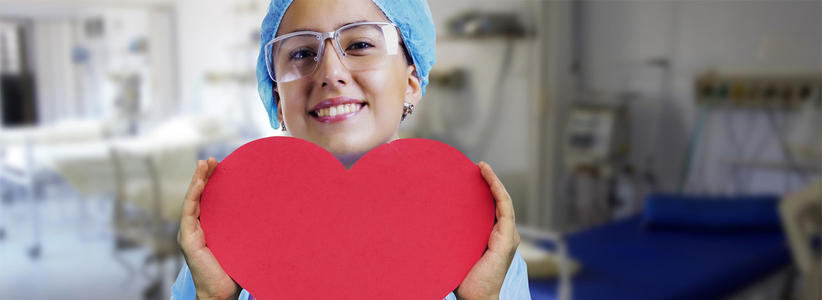 infermiera con cuore di cartoncino in mano